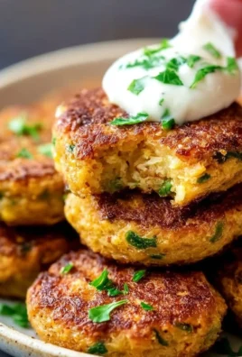 Crispy chickpea fritters served with dipping sauce on a plate.