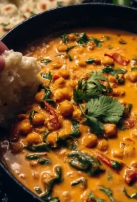 Creamy coconut chickpea curry served in a bowl with fresh herbs