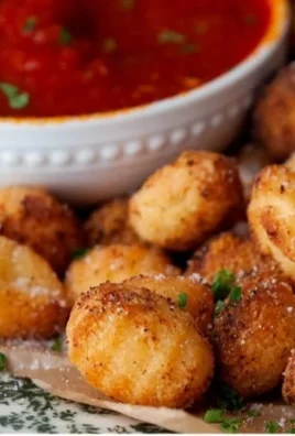 Crispy air fryer gnocchi served on a plate with herbs and sauce