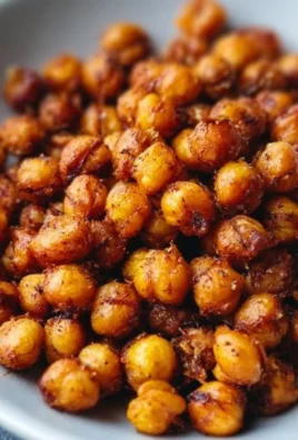 Bowl of crispy roasted chickpeas seasoned with spices and herbs.