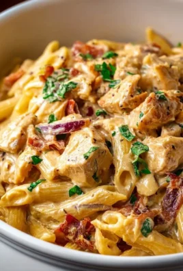 Crock Pot Creamy Cajun Chicken Pasta served in a bowl with fresh herbs