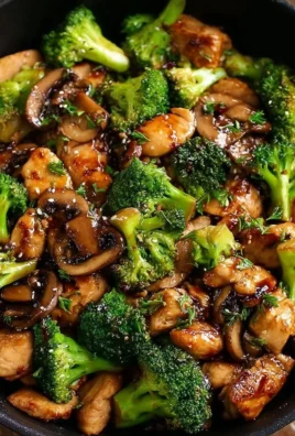 Next-level chicken stir-fry with broccoli and mushrooms in a skillet.