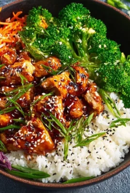Delicious Sticky Teriyaki Chicken Bowl served with vegetables and rice.