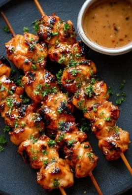 Delicious Bang Bang Chicken Skewers grilled to perfection with spicy sauce