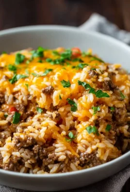 Cheesy ground beef and rice casserole topped with melted cheese