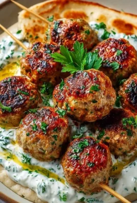 Delicious Chicken Kofta with creamy garlic yogurt sauce served on a plate