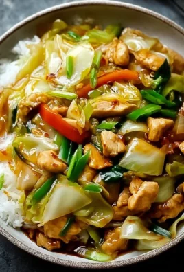 Chinese chicken cabbage stir-fry dish served on a plate with vegetables