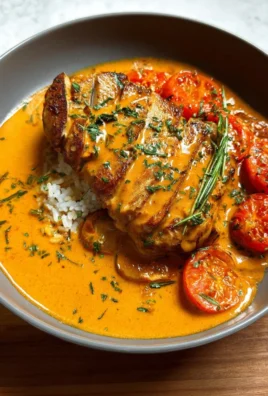 Creamy tomato chicken breast served with herbs on a plate