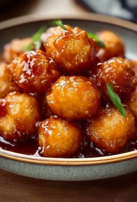 Crispy Chinese chicken balls served with a side of sweet and sour sauce.