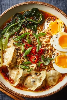 Delicious Dumpling Ramen Bowl topped with fresh ingredients and savory broth.