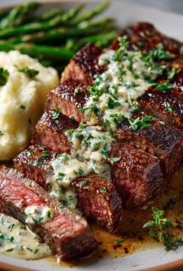 Delicious Garlic Butter Steak with creamy Parmesan sauce served on a plate.