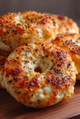 Garlic-Parmesan bagels topped with cheese, soft and chewy, high-protein breakfast option