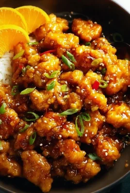 Gluten-free orange chicken served with vegetables on a plate