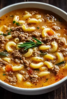 A bowl of delicious Hamburger Soup with Macaroni topped with herbs.