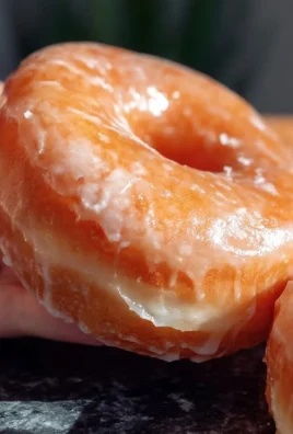 Homemade glazed donuts fresh out of the oven, topped with shiny glaze.