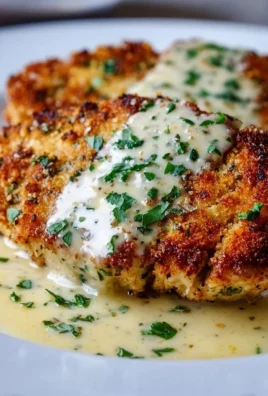 Delicious Parmesan Crusted Chicken served with creamy garlic sauce