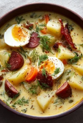 A bowl of Polish Potato Soup (Kartoflanka) garnished with herbs.