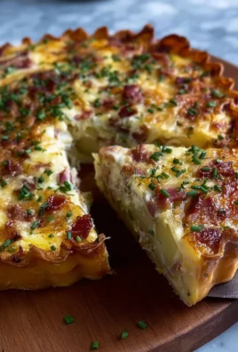 Delicious potato tart with leeks and bacon served on a plate