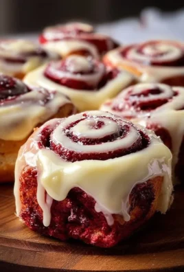 Red Velvet Cinnamon Rolls topped with cream cheese icing
