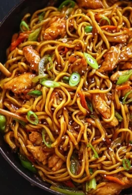 Delicious sticky garlic chicken noodles served in a bowl with vibrant vegetables.