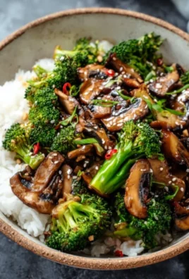 Colorful vegan broccoli and mushroom stir fry in a skillet.
