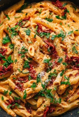 Vegan creamy sun dried tomato pasta served on a white plate