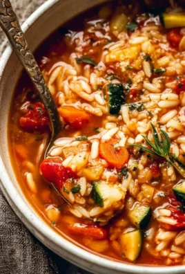 Bowl of hearty Vegetable Orzo Soup with colorful vegetables and orzo pasta